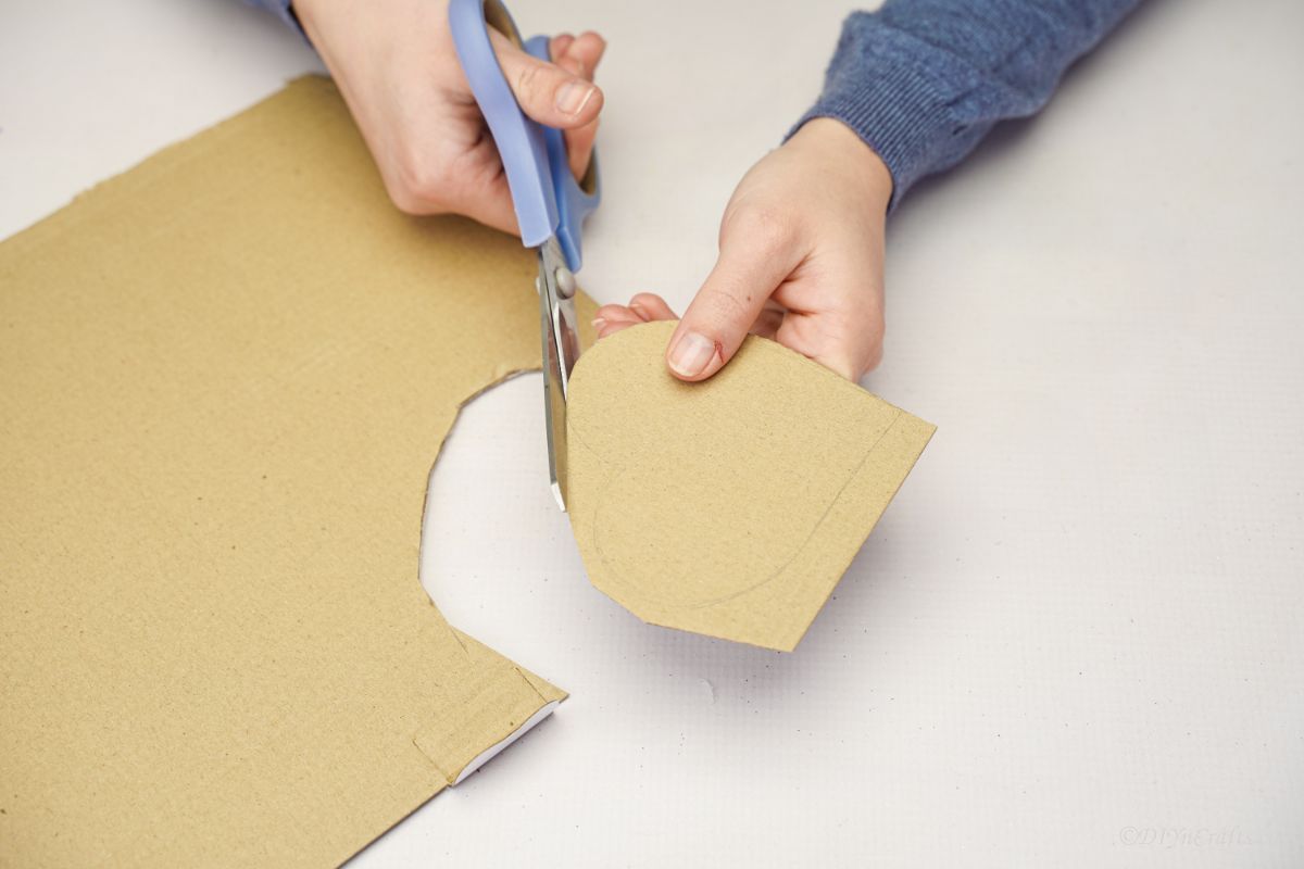 cutting cardboard with gray scissors