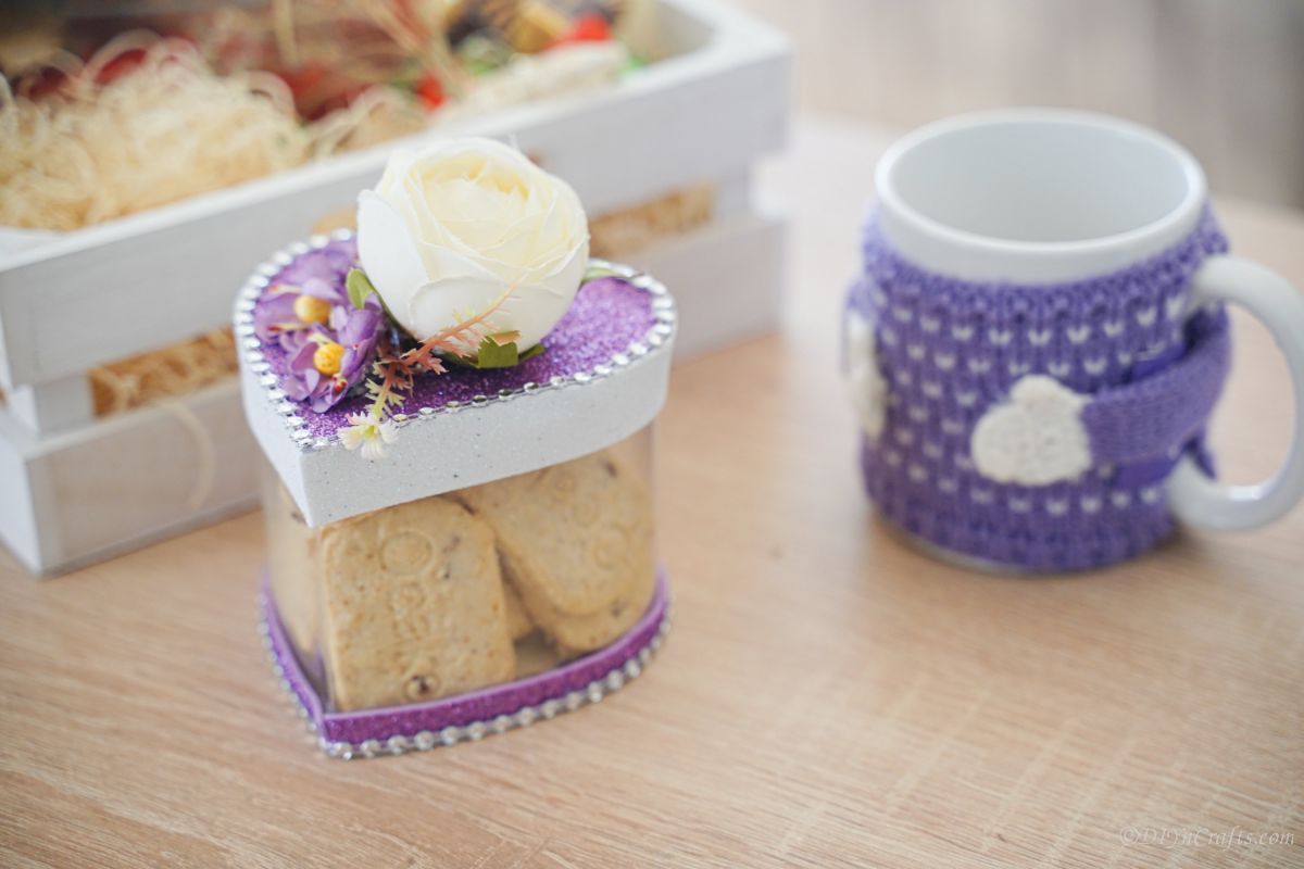 purple and white heart shaped box on table by coffee mug