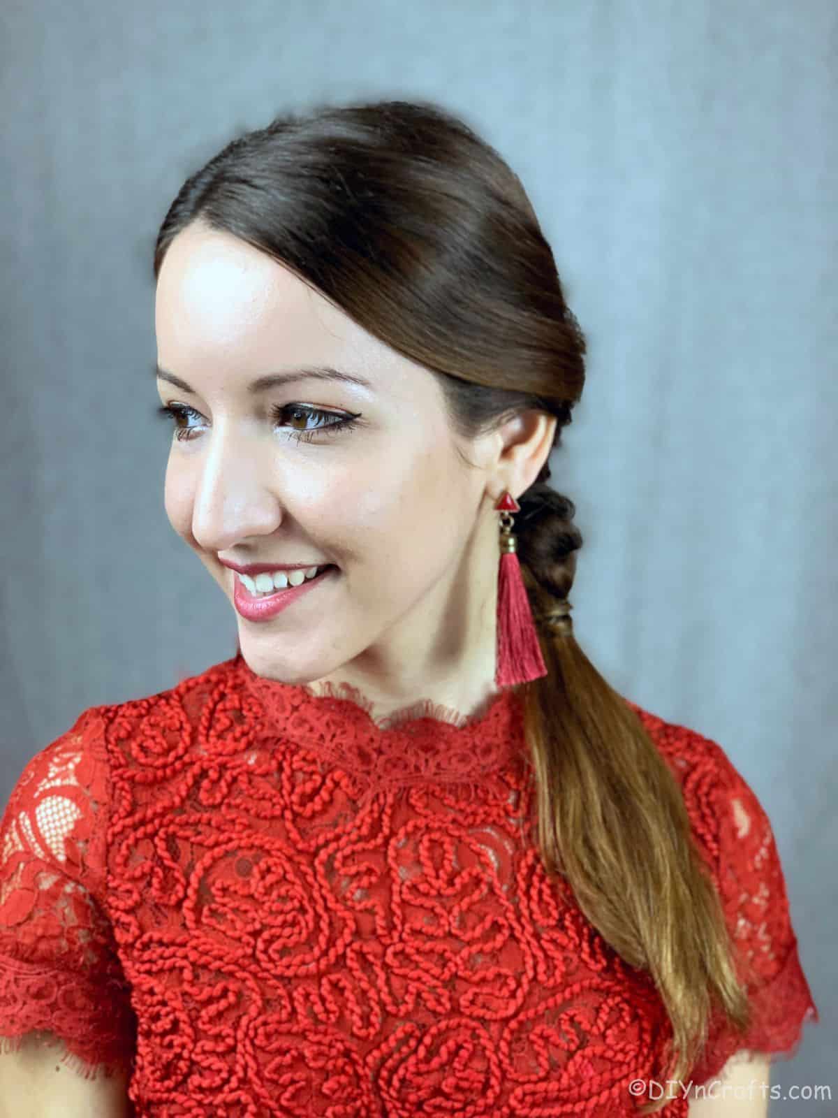 woman in lace red shirt with hair over her shoulder