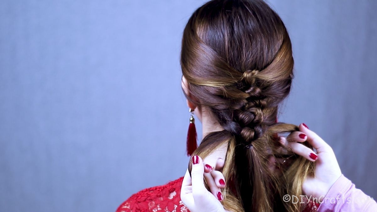 woman in red having her hair braided