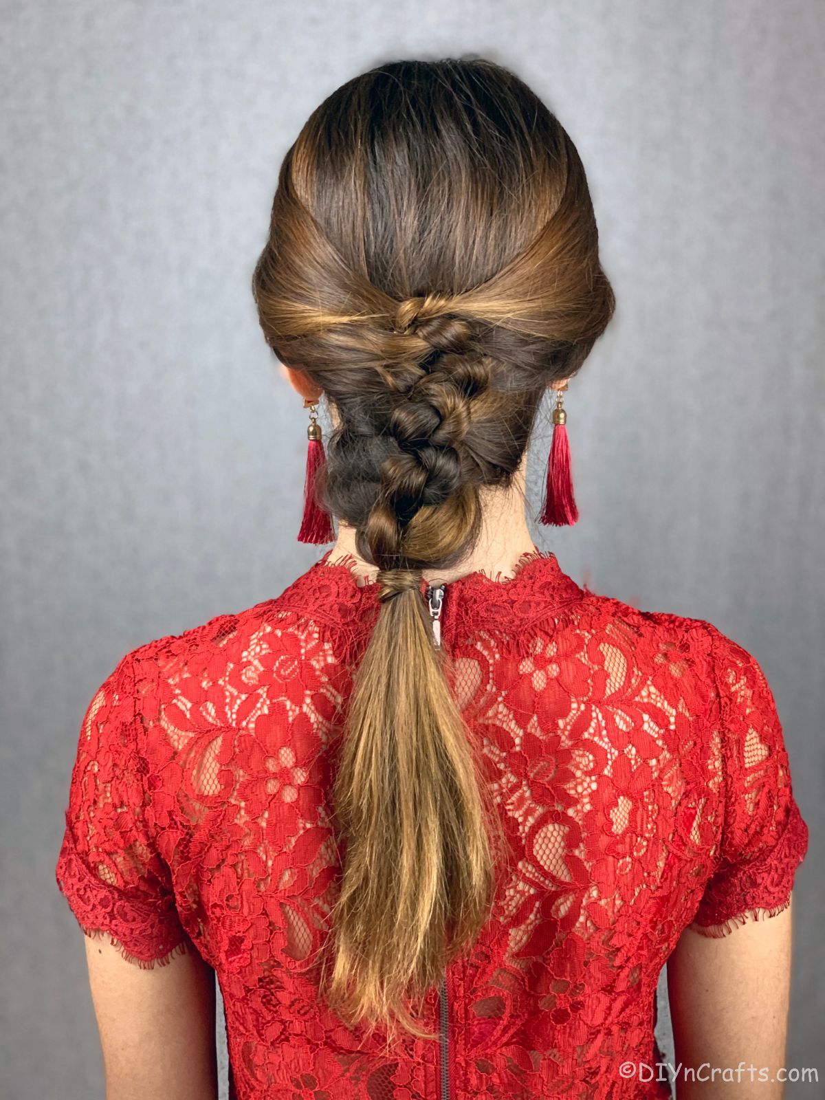woman in red shirt with knotted braided hair
