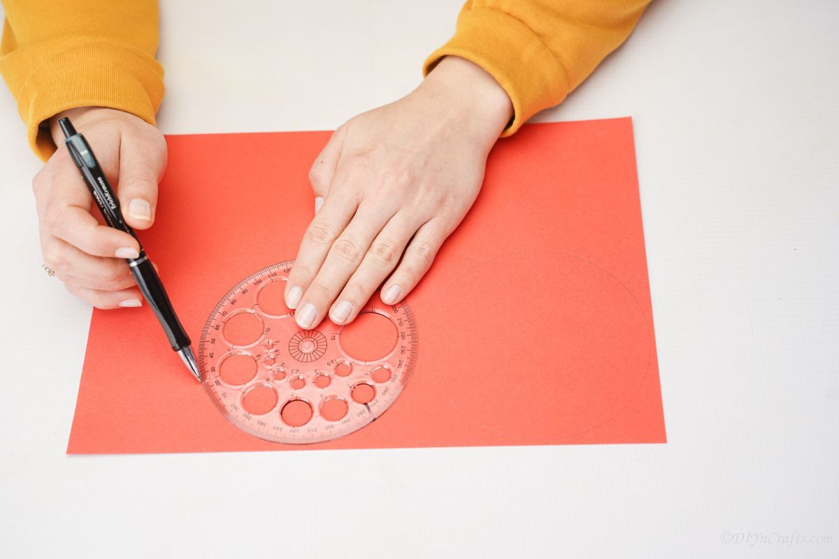 circle being traced onto red paper