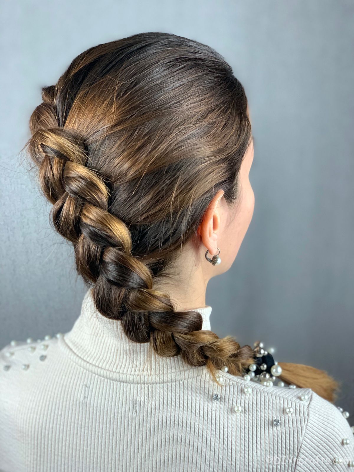 woman in white with side dutch braid hanging over shoulder