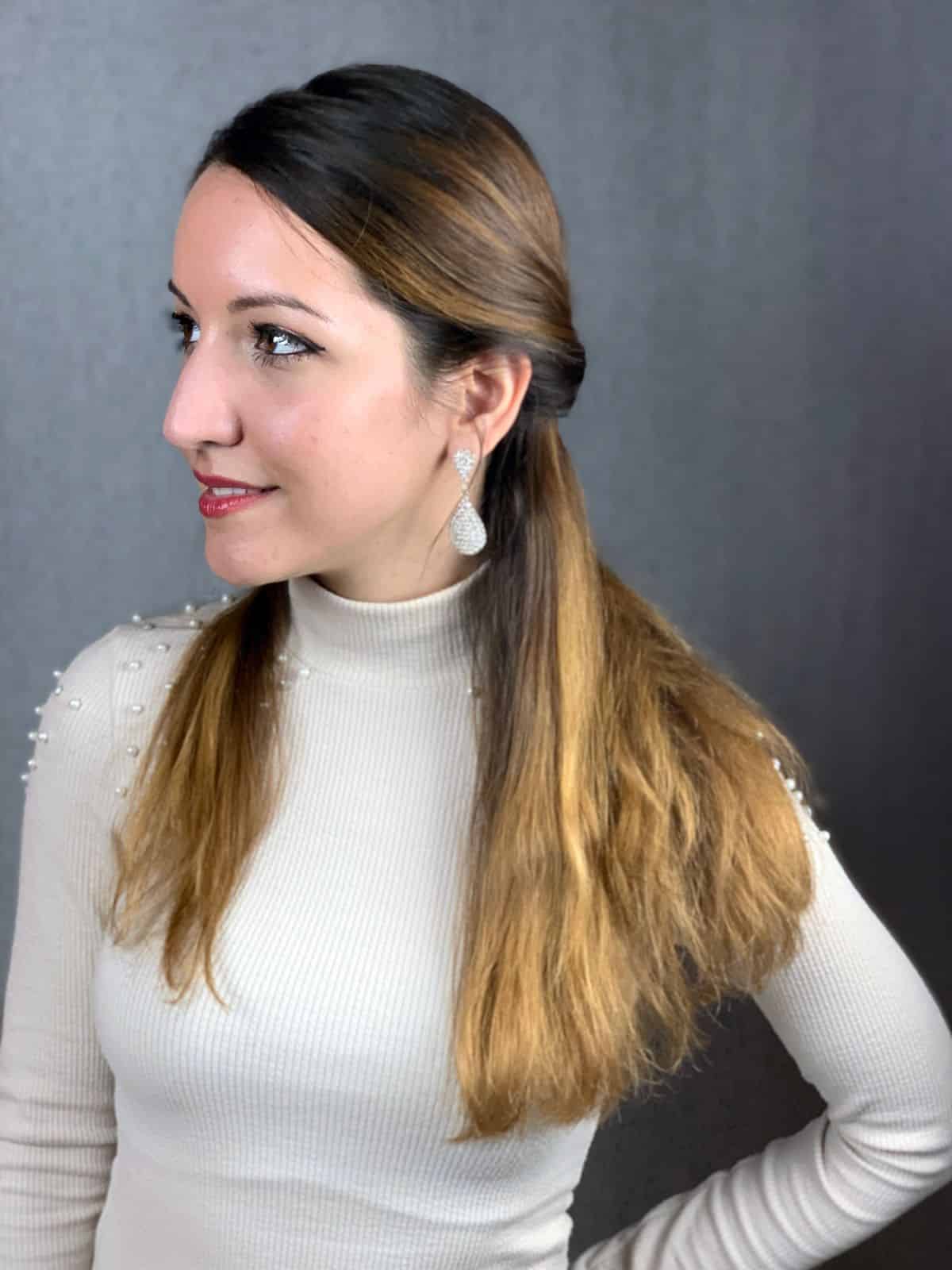 hair half up on lady with brown hair wearing white shirt