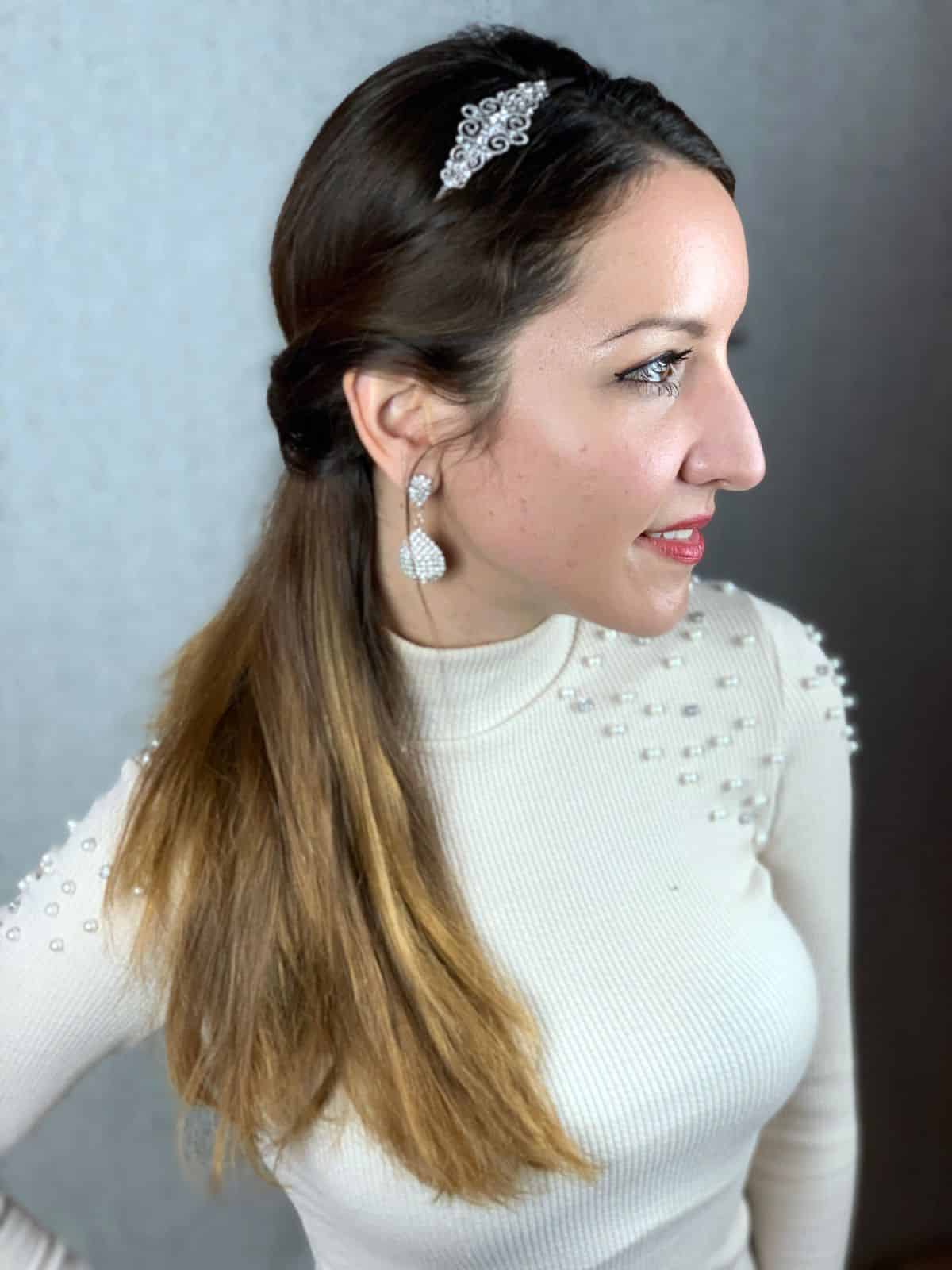 beaded headband on crown of head on woman in white sweater