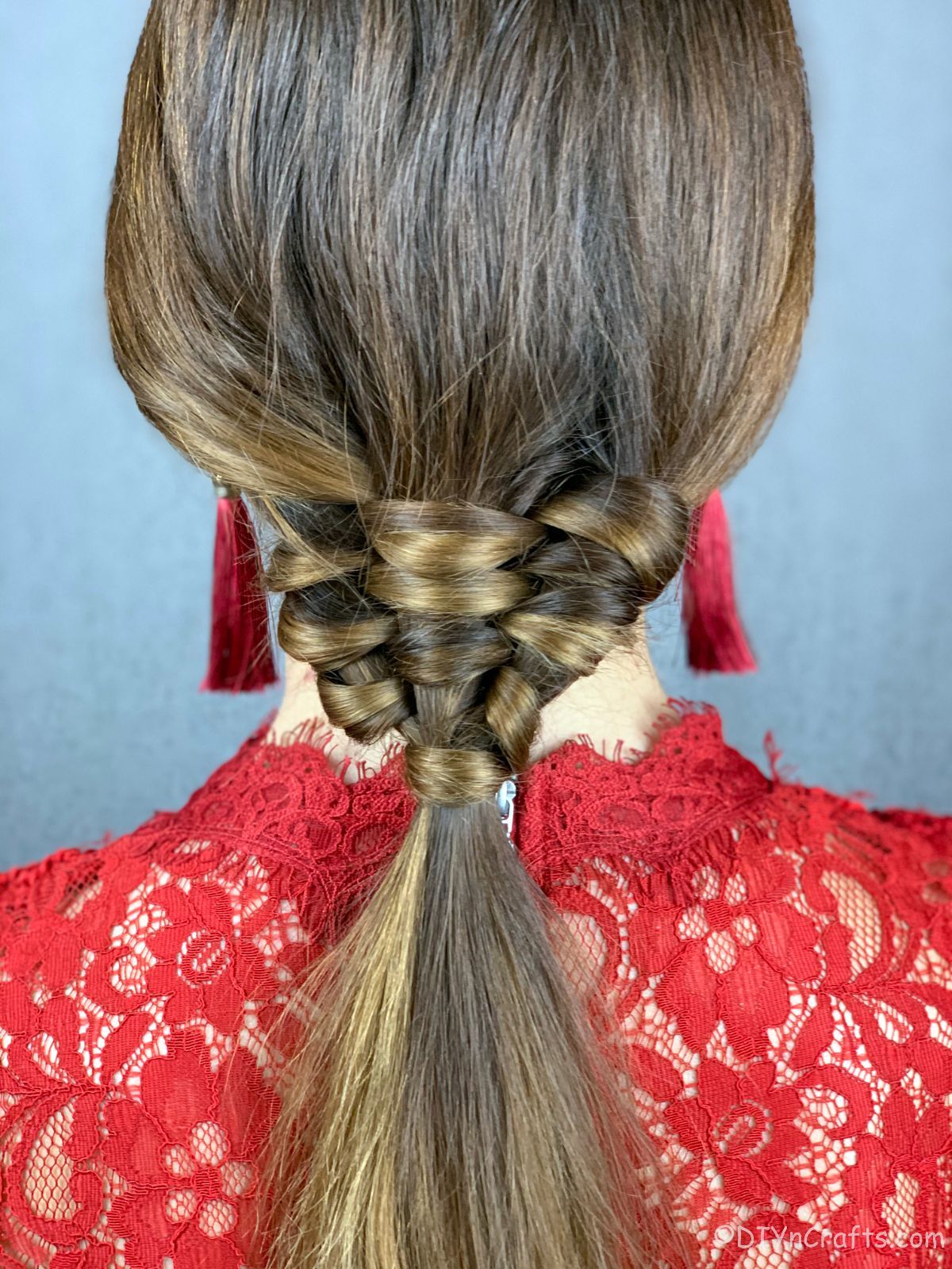 woman in red shirt with woven braid ponytail