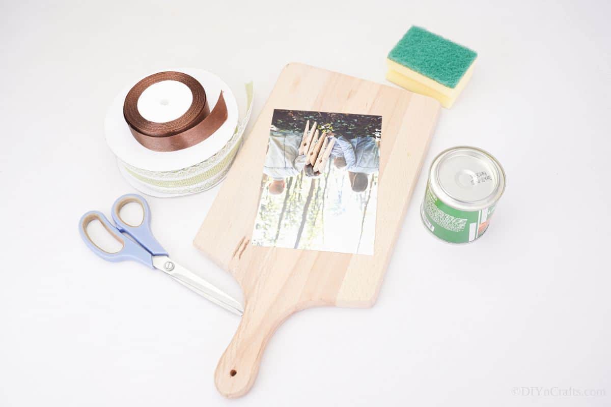 supplies to make cutting board photo stand on white table