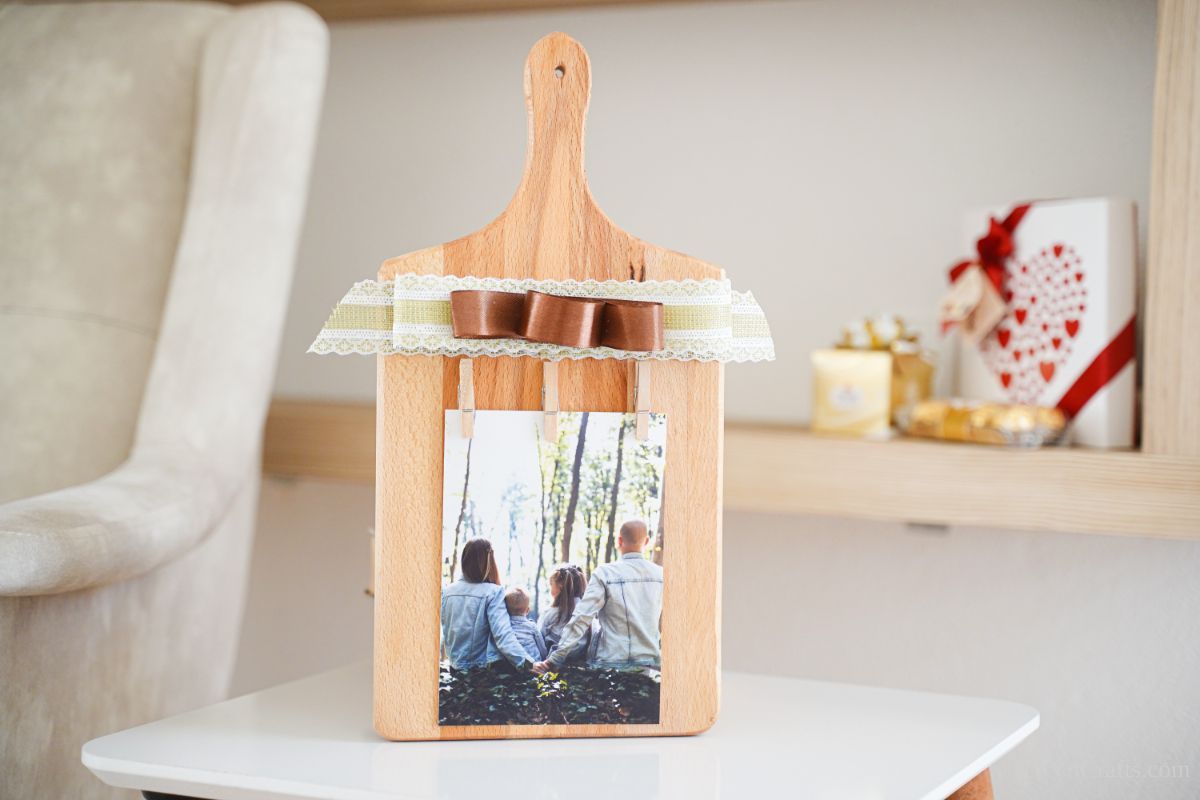 wood picture frame with brown bow on table