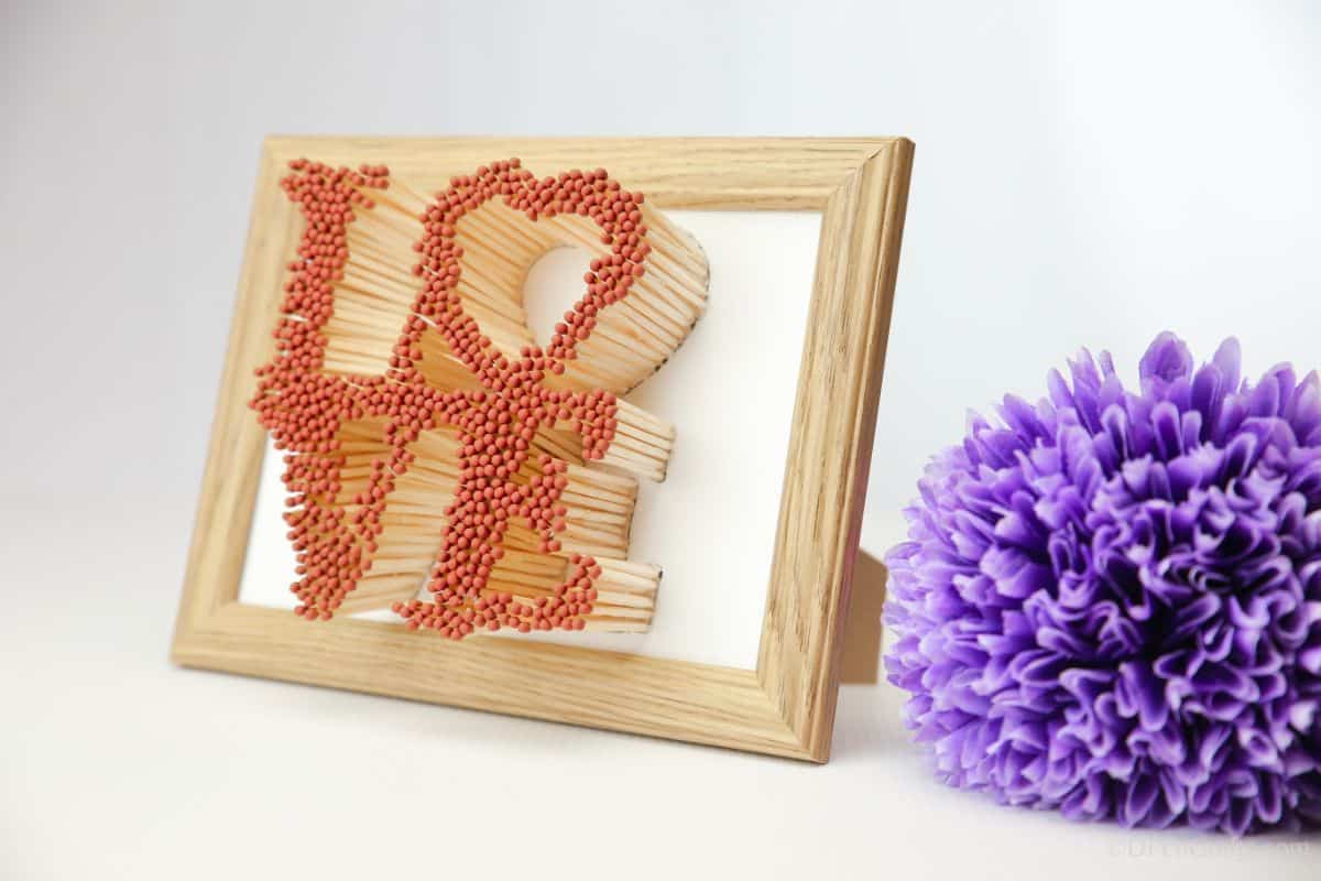 love sign in picture frame by purple flower