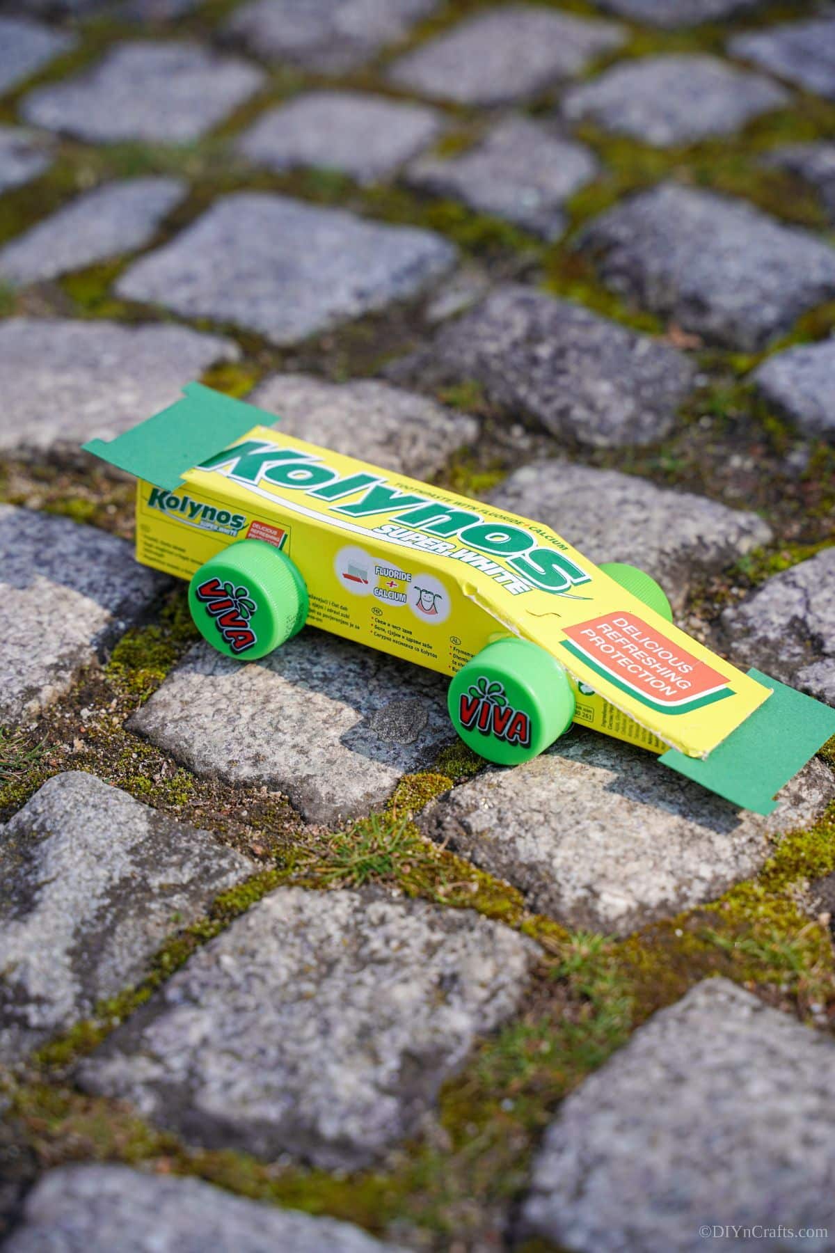 upcycled toothpaste box race car on stone path