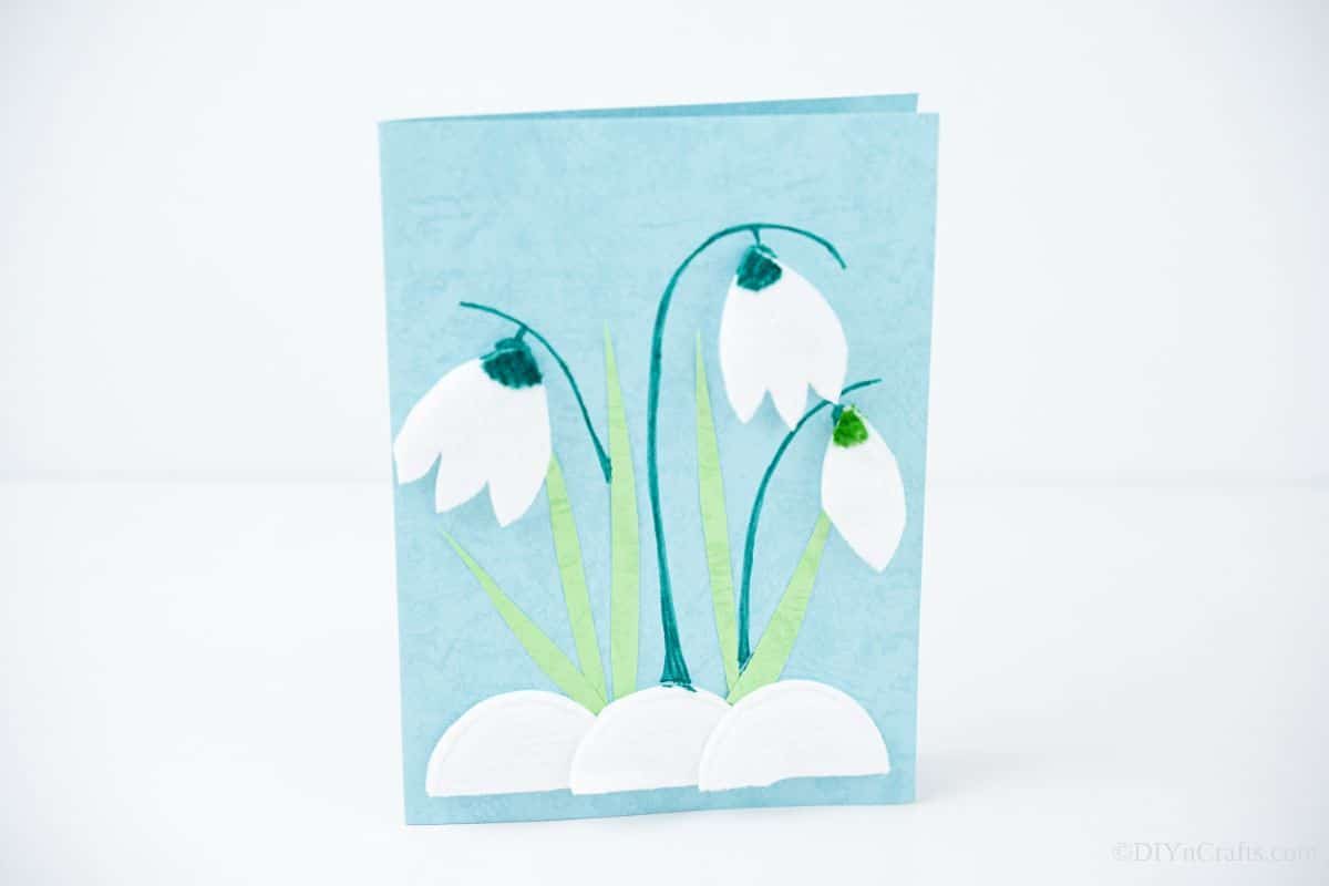 blue, green, and white tulip handmade card on white counter