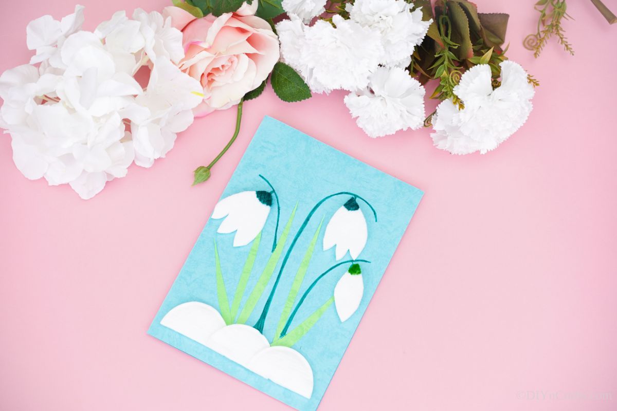 pink background behind blue green and white handmade tulip card