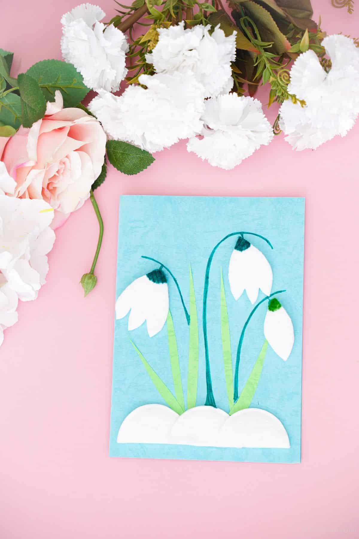blue and green tulip card laying on pink table