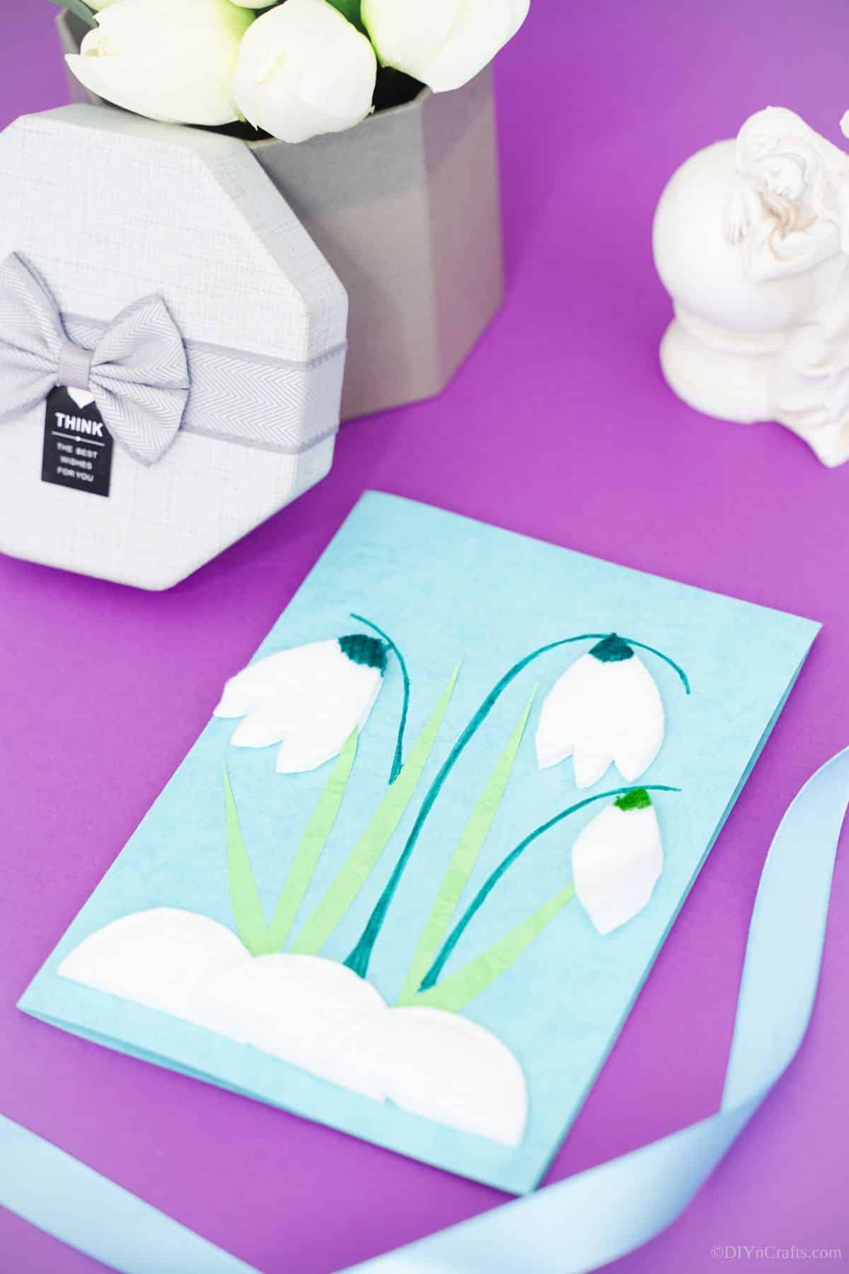 tulip handmade card on purple table by gift box