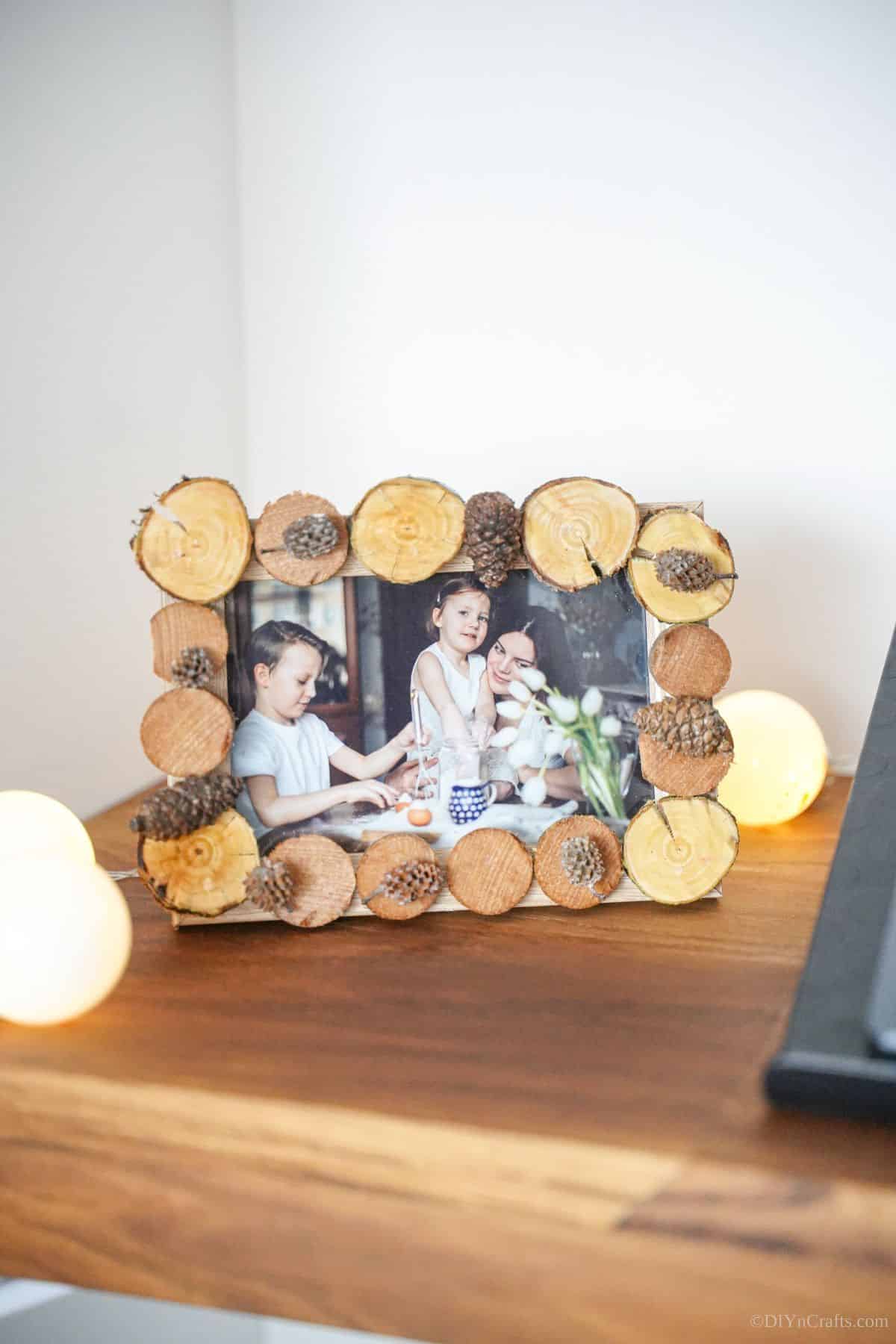 wood slice picture frame on desk by lights