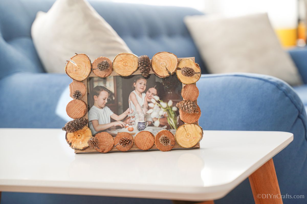picture frame with rustic exterior on table by blue sofa