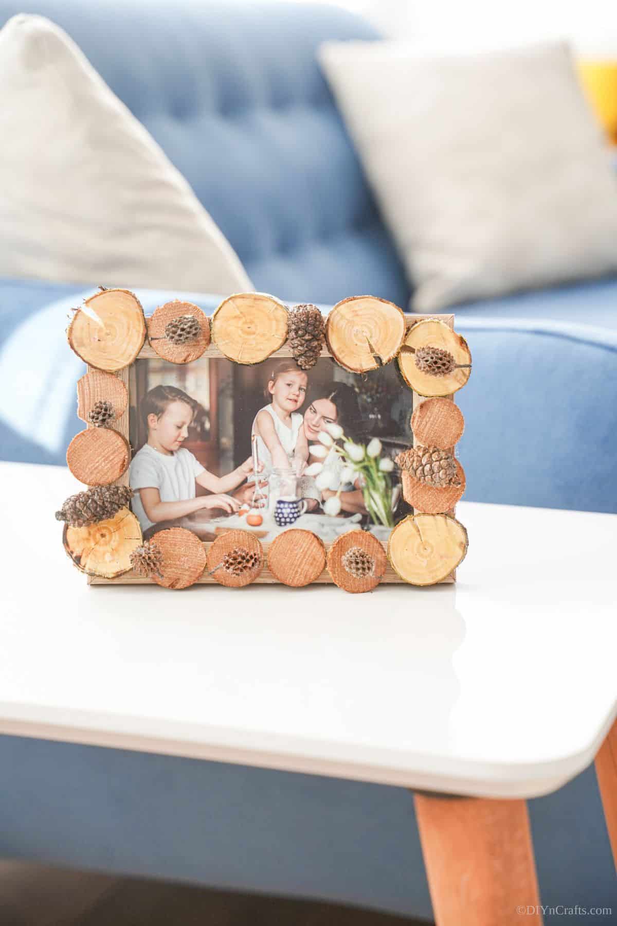 rustic wood slice picture frame on white end table