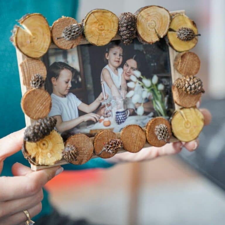 woman holding wood slice picture frame
