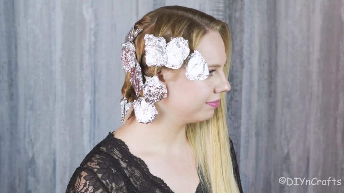 side of blondes head wrapped in foil