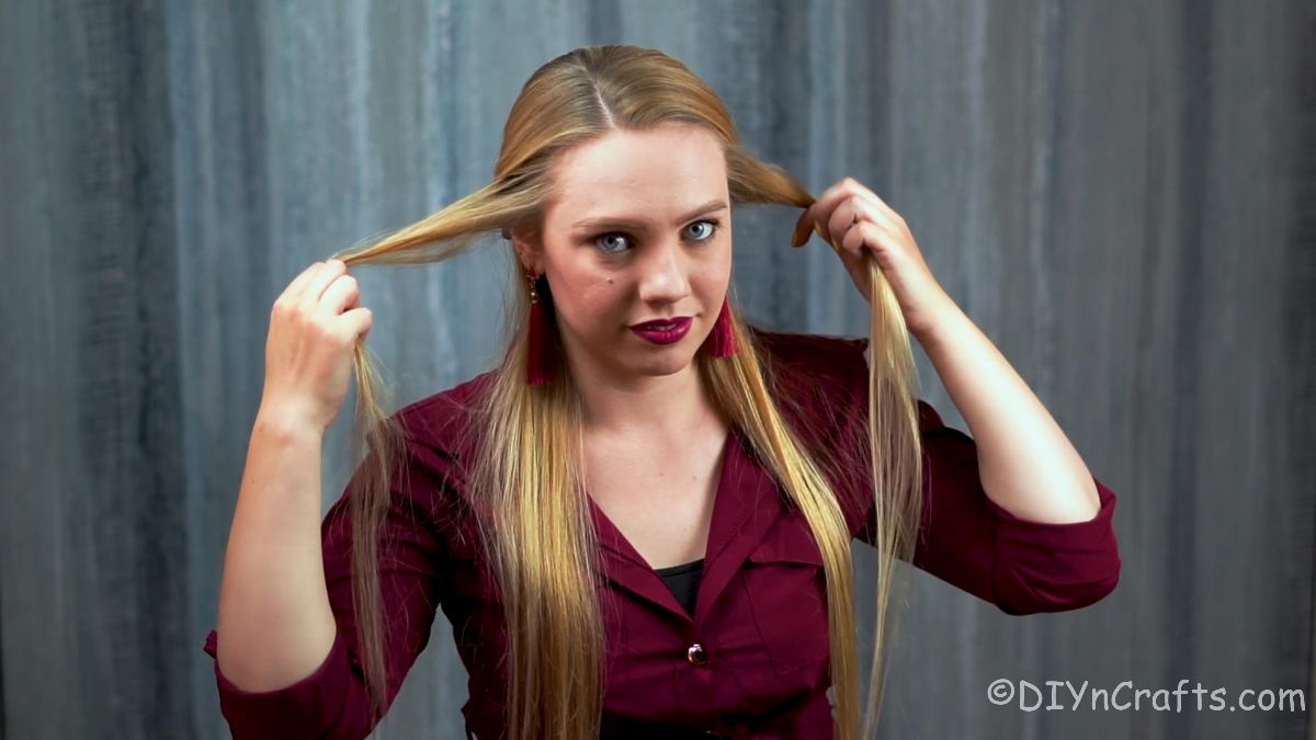 woman holding front sections of hair out