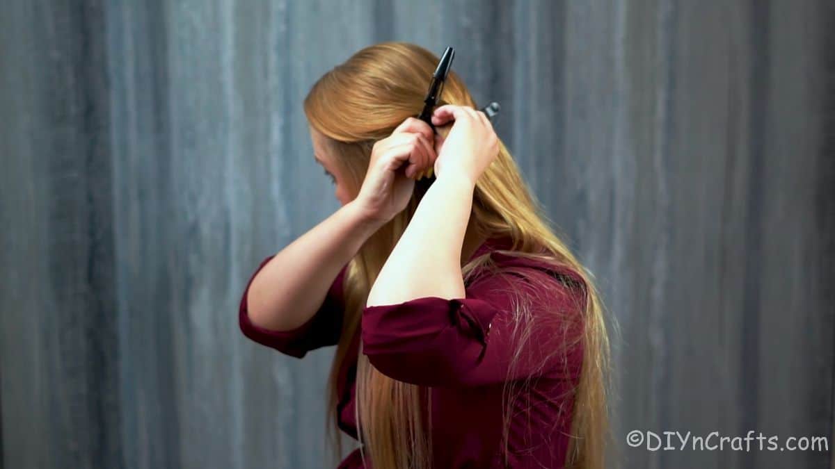 lady clipping hair back