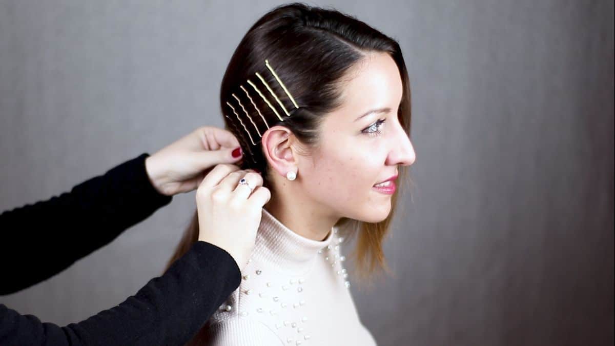 bobby pins along the side of head behind ear