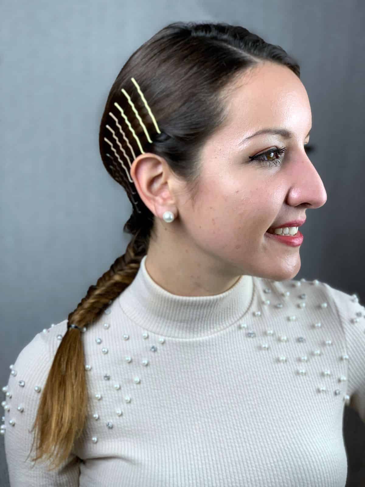 smiling woman with bobby pins on side above ears