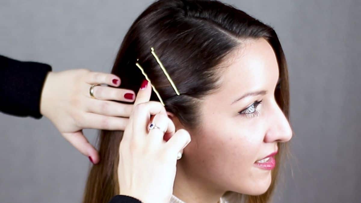 a bobby pin being pushed into side of bobby pin hairstyle
