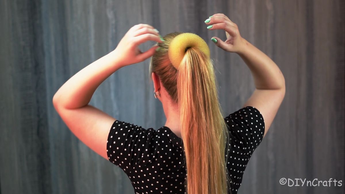 hair donut being put over ponytail