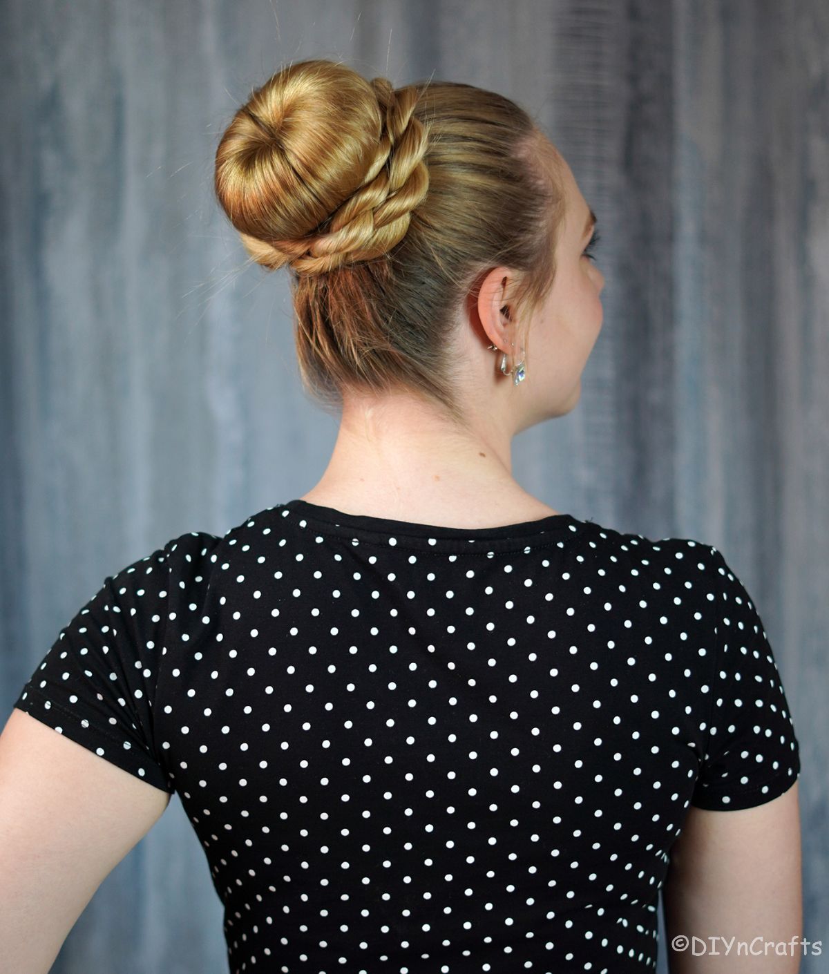 lady in black and white polka dot dress with high bun
