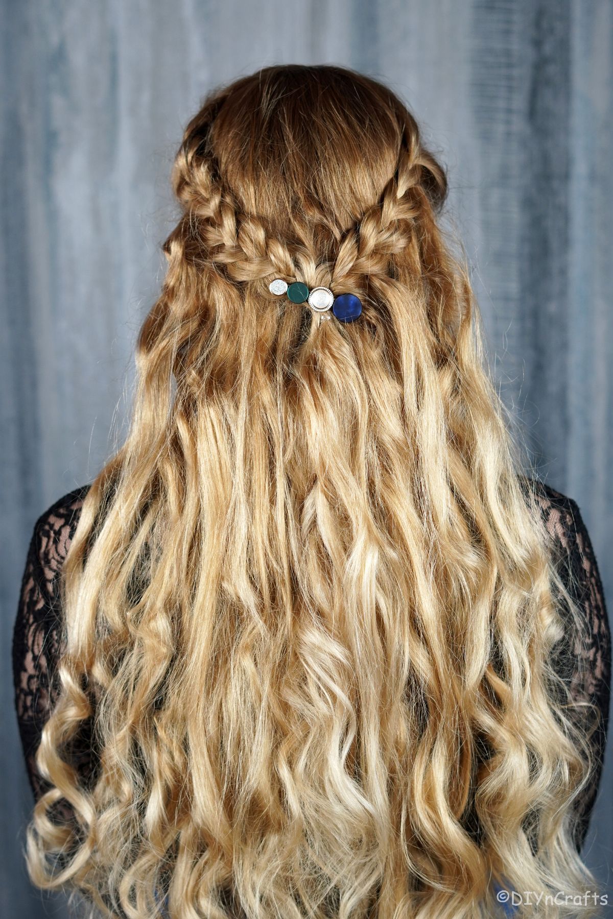 back of braided crown half up half down hairstyle on blonde woman in black shirt