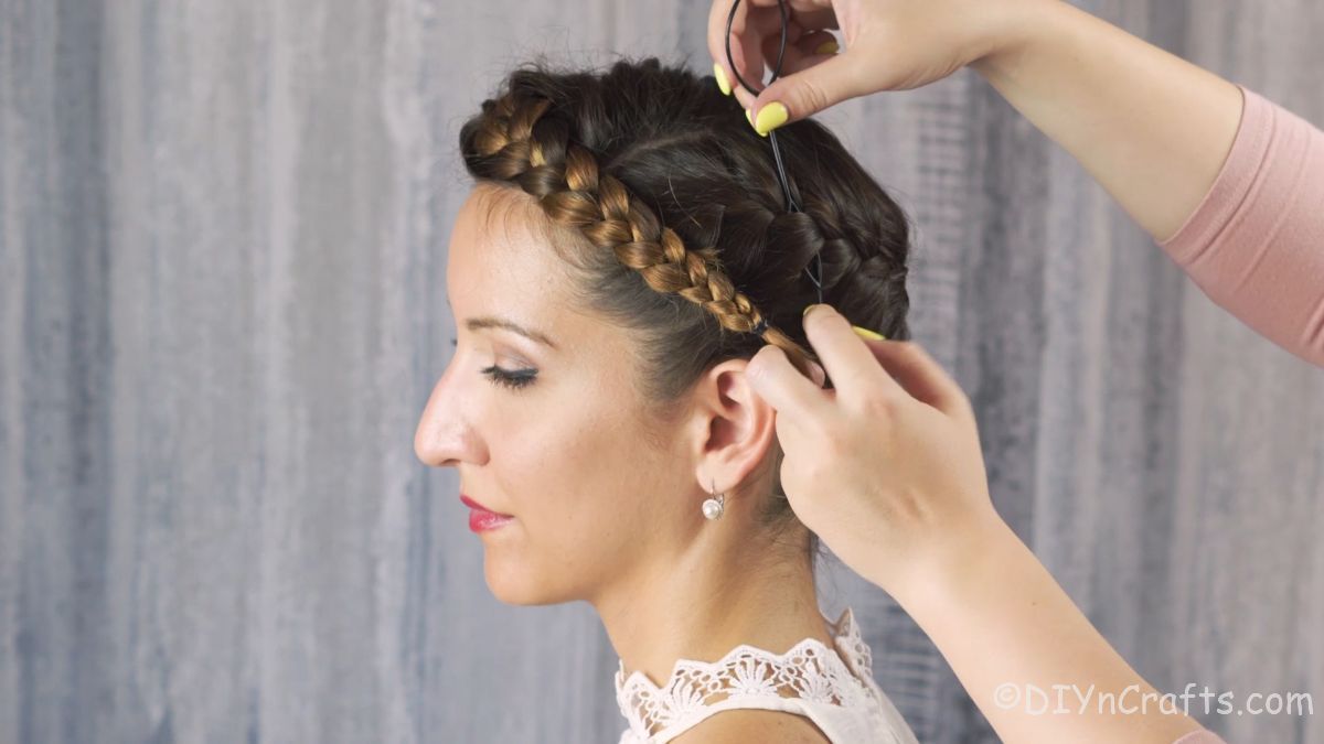 topsy tail being used to connect crown french braid