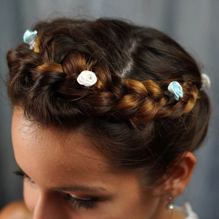 mini white flowers in crown french braid