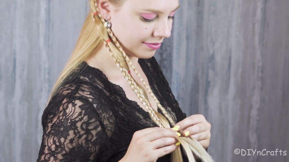 woman connecting braids with hair band