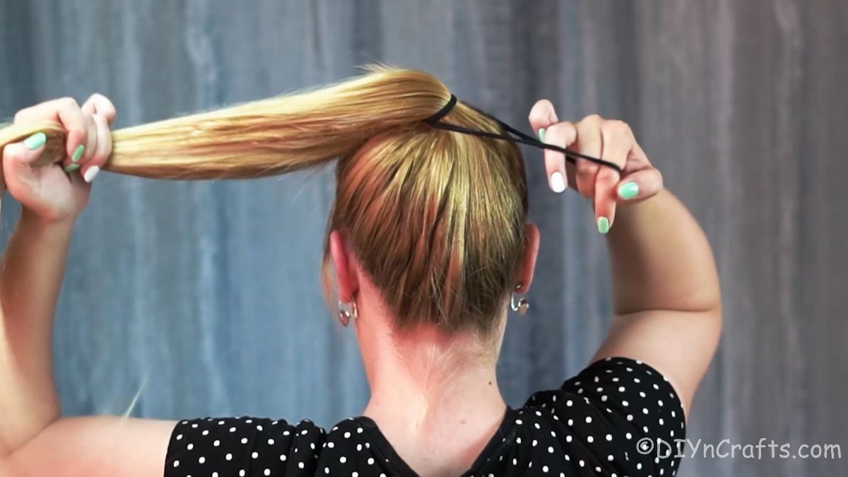 hair being put into high ponytail