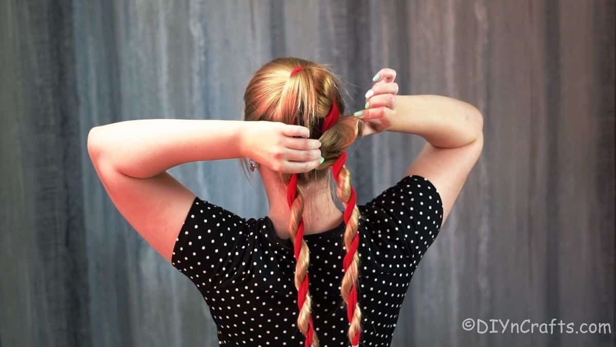 hands loosening braids