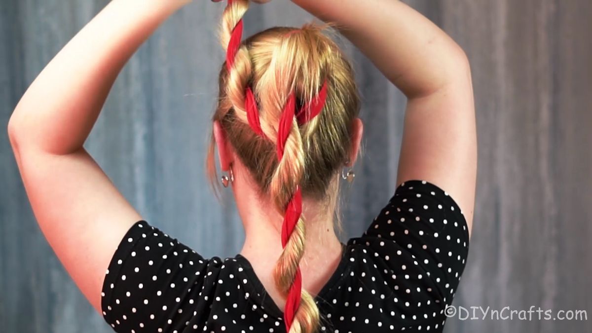 hair and ribbon twist braid being wrapped into bun