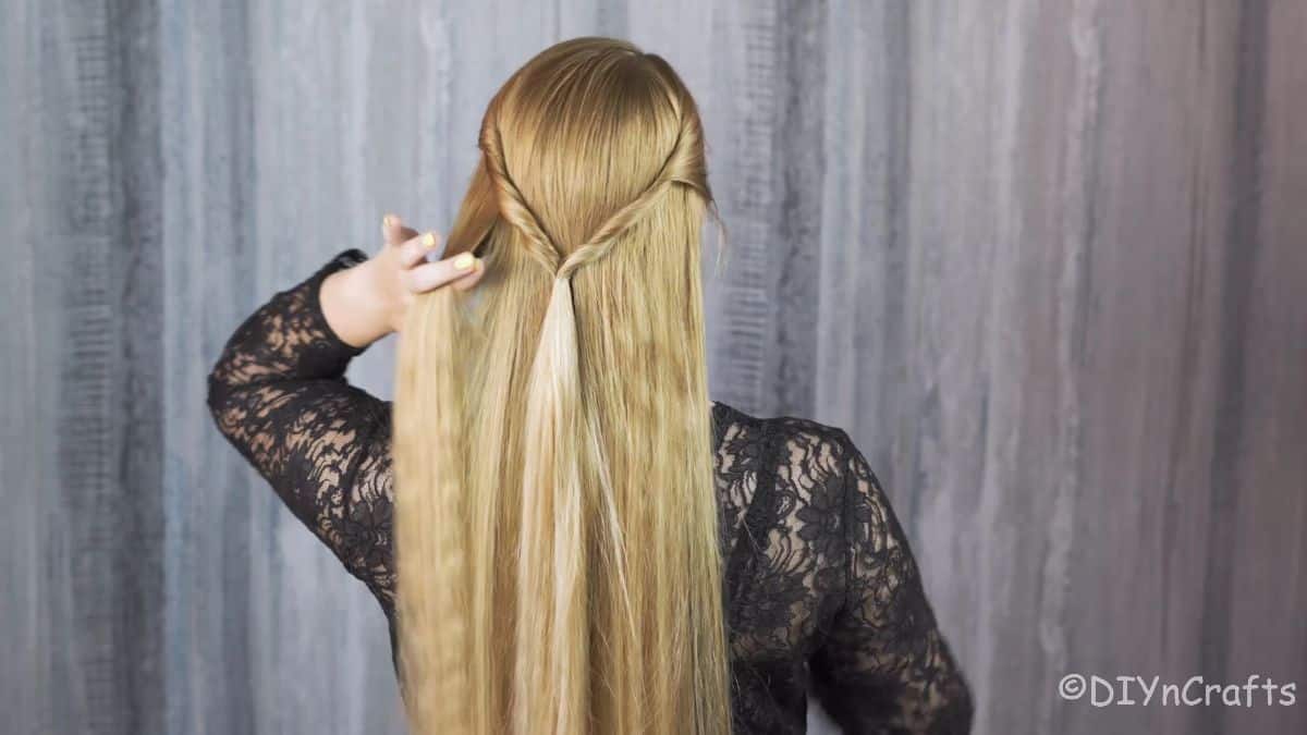 blonde woman touching back of braid