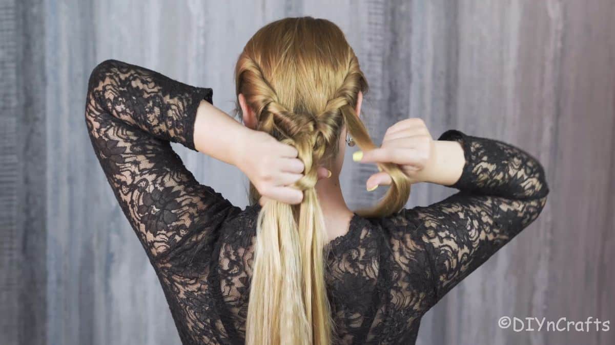 separating hair to braid ponytail