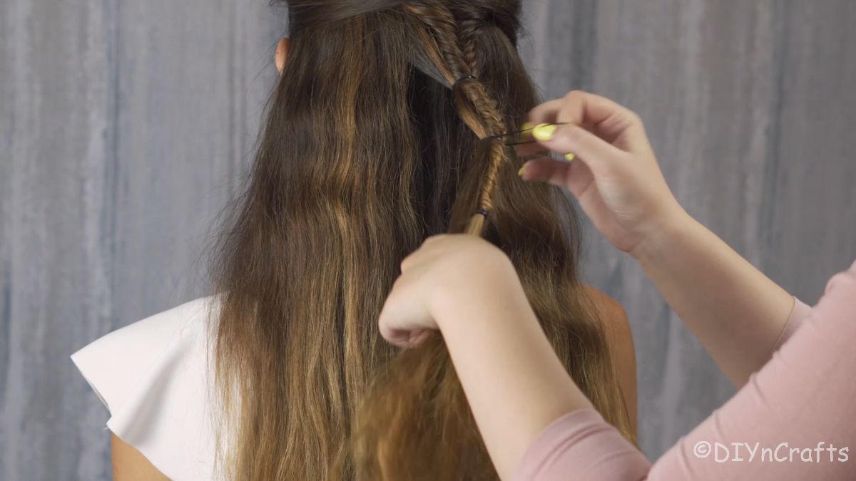 tying extra hair onto braids