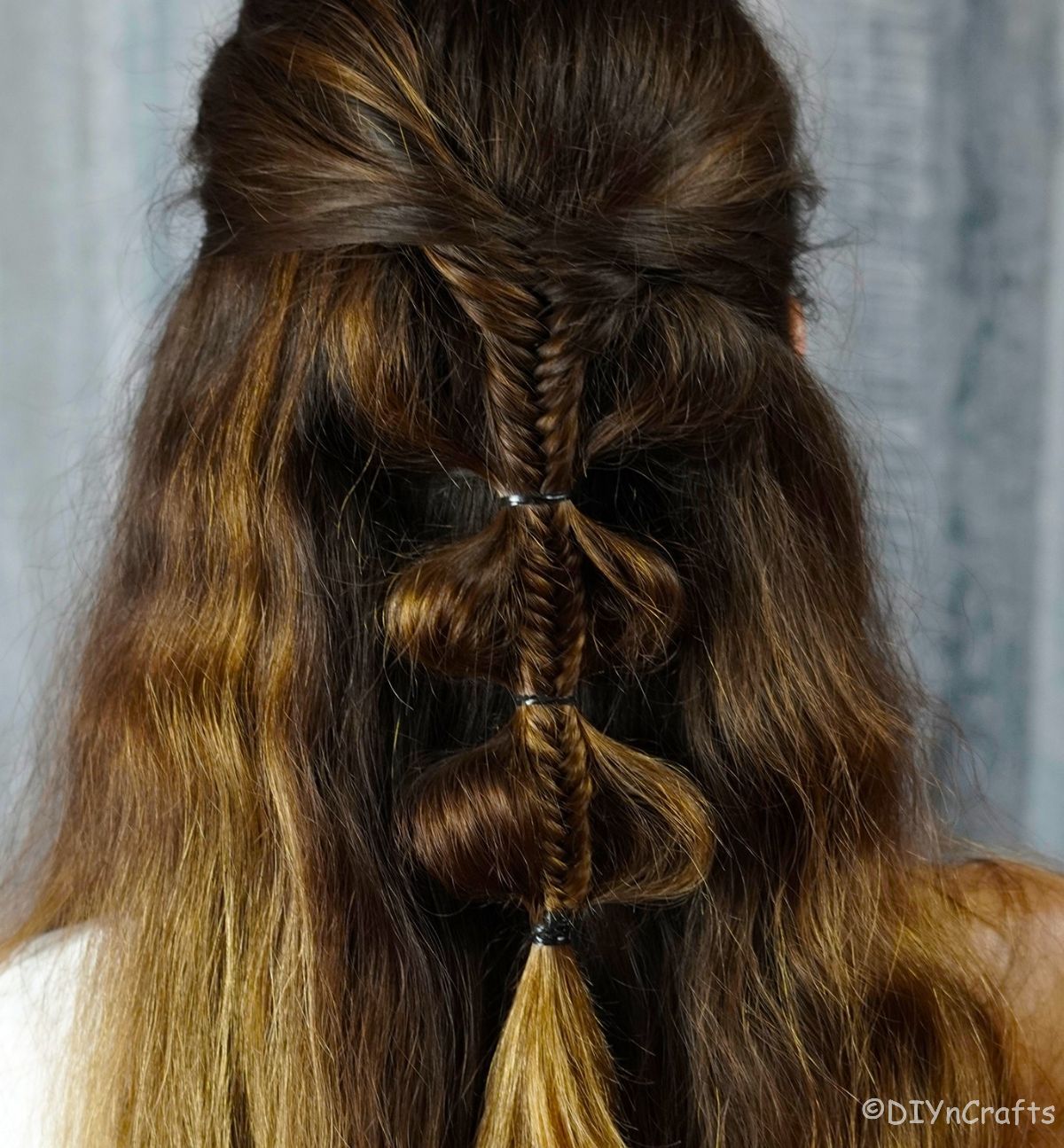 half up hairstyle with palm tree braid on back