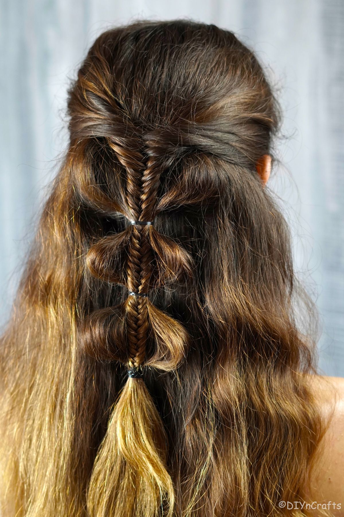 palm tree braids in half up hairstyle on brunette