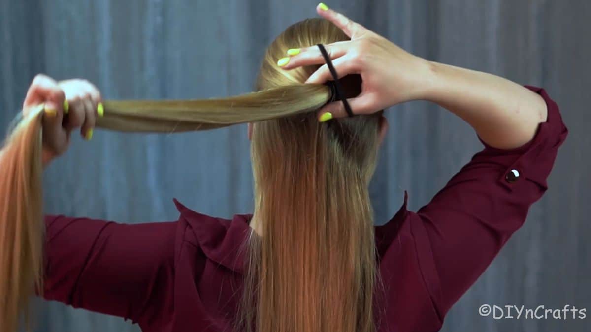 ponytail holder being added to half up hair