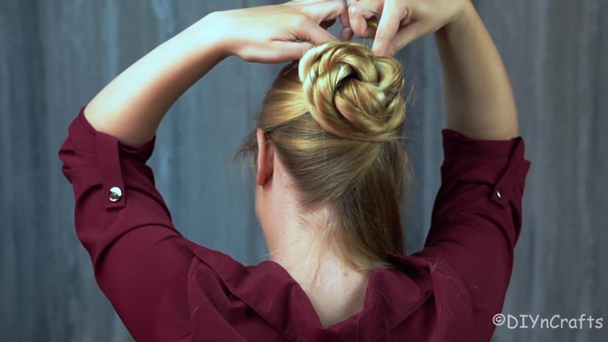 bobby pins being added to hold bun in place