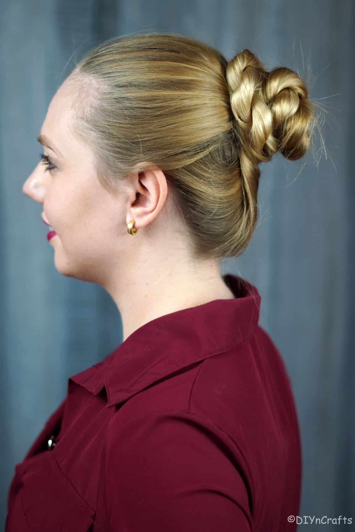 blonde in red shirt with twisted rope bun