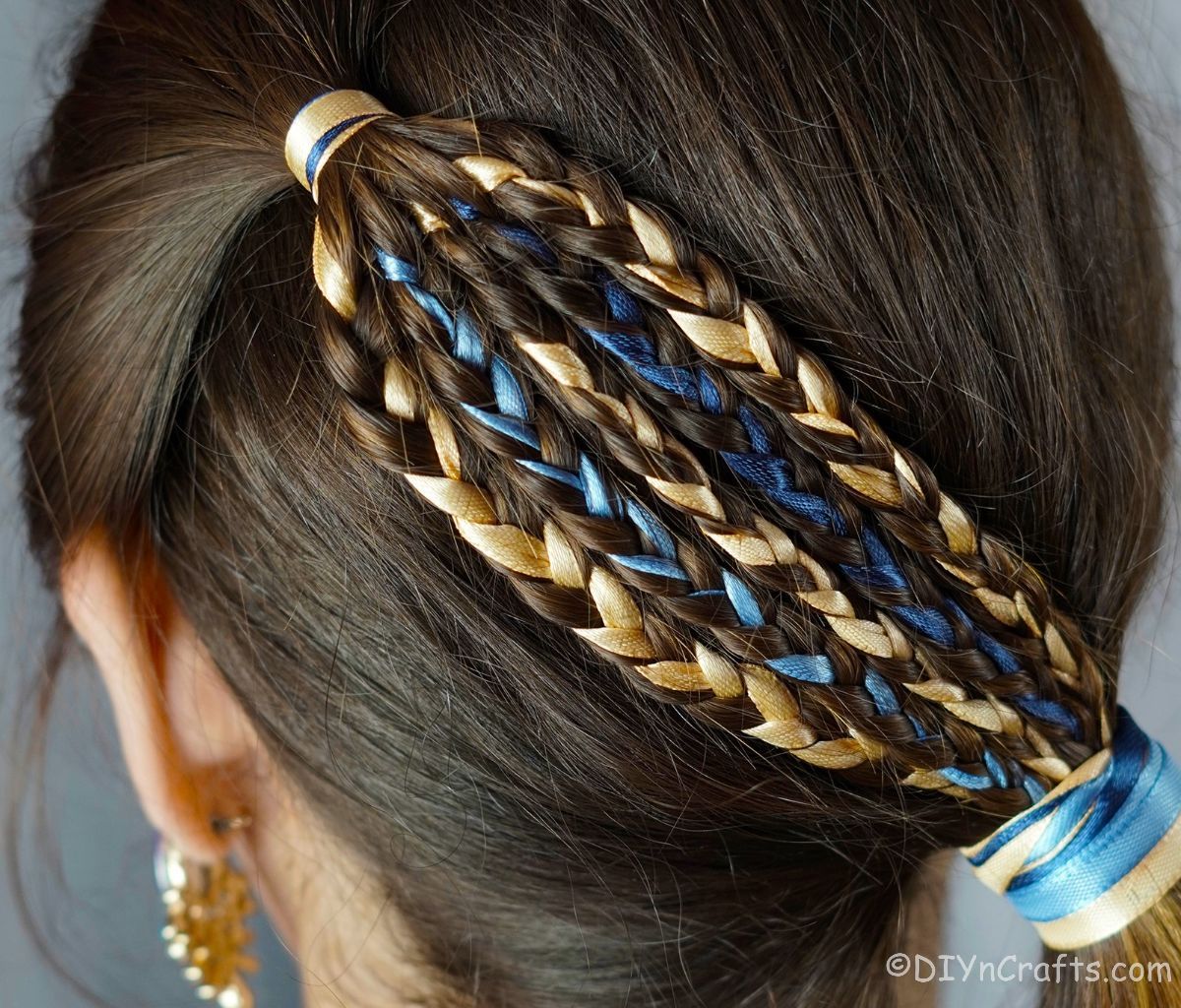 ribbon in braids on back of head of brunette