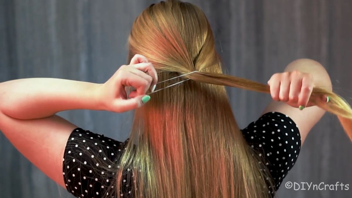 hair tie securing ponytail on back of head