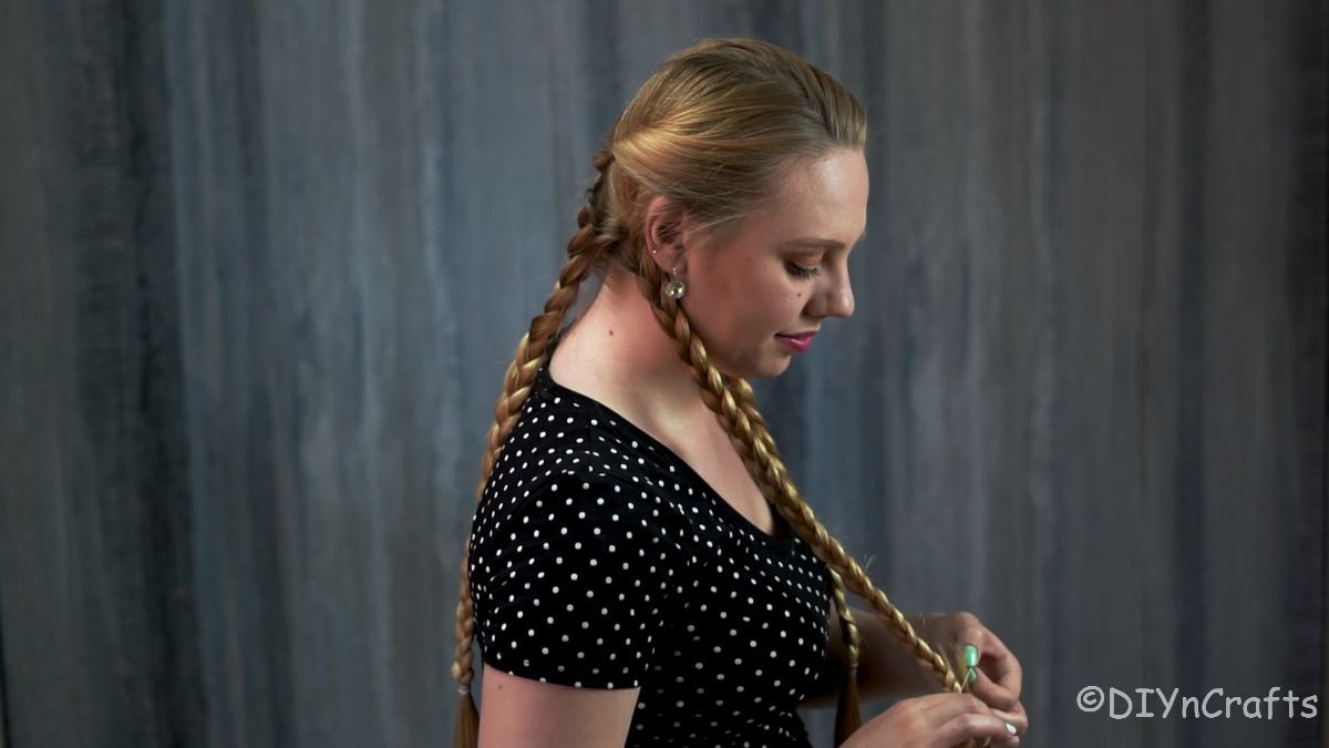 woman braiding blonde hair