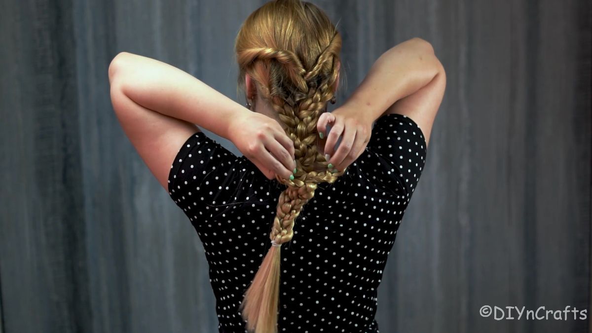 woman loosening edes of braid