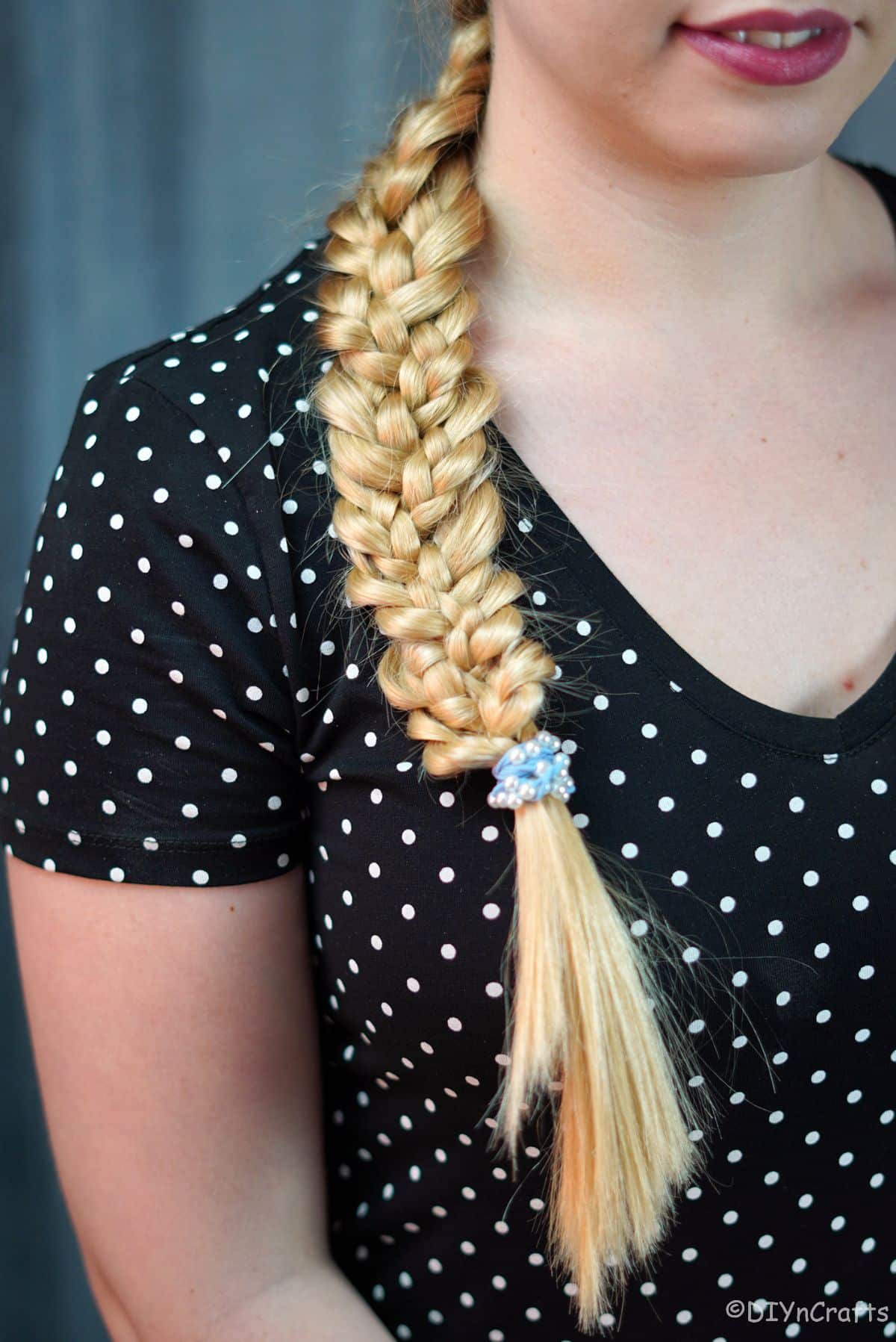 blue hair tie on the end of stacked braid